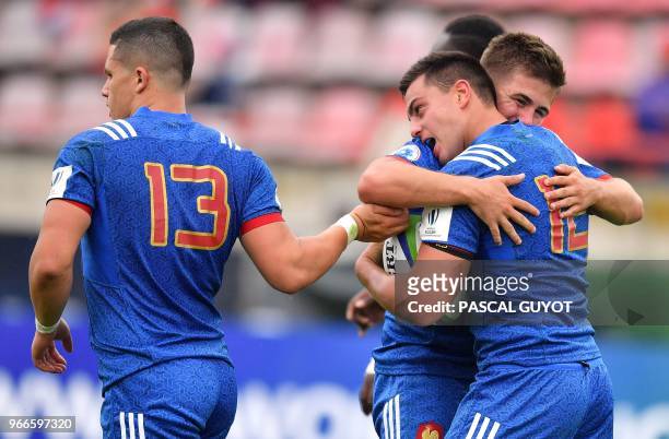 France's Arthur Vincent is congratulated by his teammates after scoring during the Rugby Union World Cup U20 championship match France vs Georgia at...