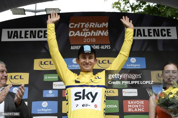 Poland's Michal Kwiatkowski celebrates his overall leader's yellow jersey on the podium at the end of a 6,6 km individual time-trial, the prologue of...