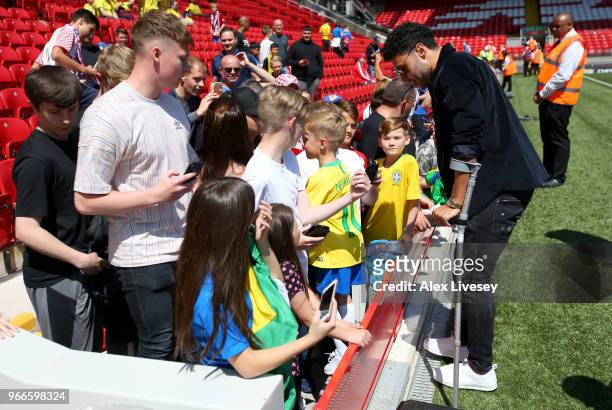 Alex Oxlade-Chamberlain of Liverpool signs autographs prior to the International Friendly match between Croatia and Brazil at Anfield on June 3, 2018...