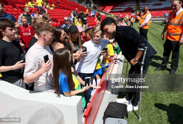 Alex Oxlade-Chamberlain of Liverpool signs autographs prior to the International Friendly match between Croatia and Brazil at Anfield on June 3, 2018...