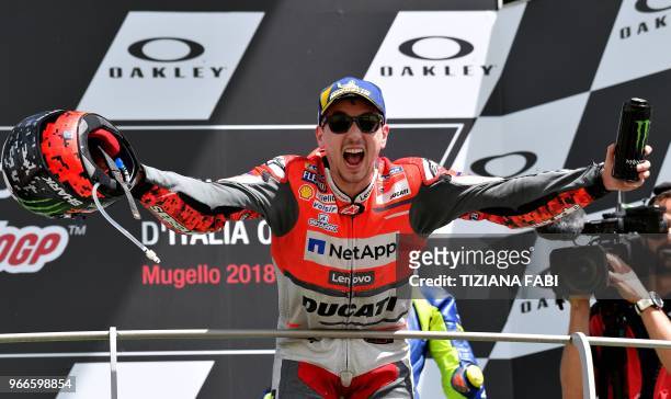 Ducati Team's Spanish rider Jorge Lorenzo celebrates on the podium after winning the Moto GP Grand Prix at the Mugello race track on June 3, 2018