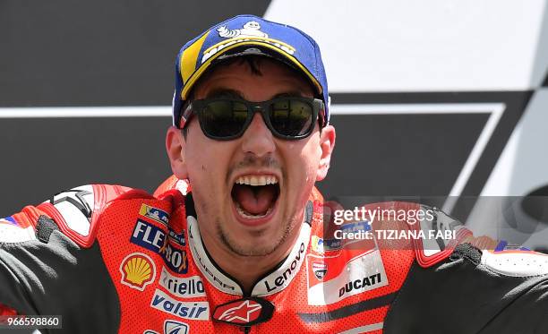 Ducati Team's Spanish rider Jorge Lorenzo celebrates on the podium after winning the Moto GP Grand Prix at the Mugello race track on June 3, 2018