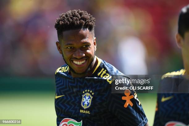 Brazil's midfielder Fred smiles as he warms up ahead of the International friendly football match between Brazil and Croatia at Anfield in Liverpool...