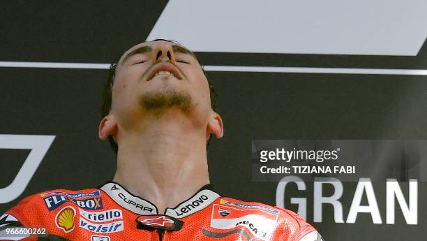 Ducati Team's Spanish rider Jorge Lorenzo celebrates on the podium after winning the Moto GP Grand Prix at the Mugello race track on June 3, 2018