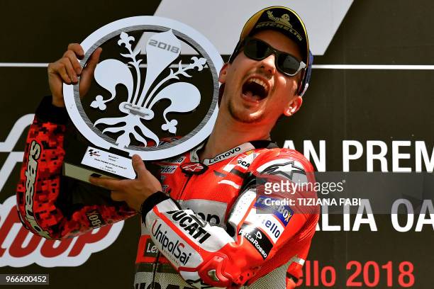 Ducati Team's Spanish rider Jorge Lorenzo celebrates on the podium after he won the Moto GP Grand Prix at the Mugello race track on June 3, 2018