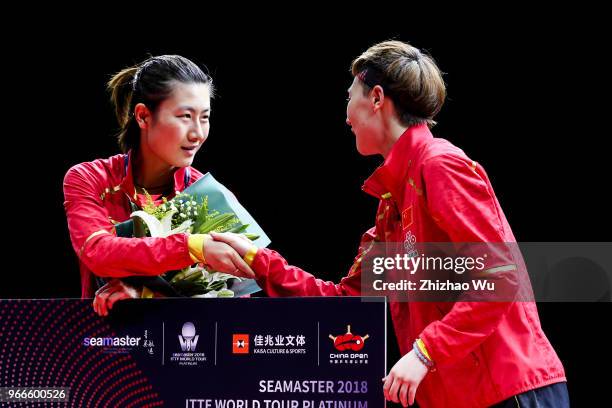 Ding Ning and Wang Manyu of China attend the award ceremony at the women's singles final compete with Wang Manyu of China during the 2018 ITTF World...