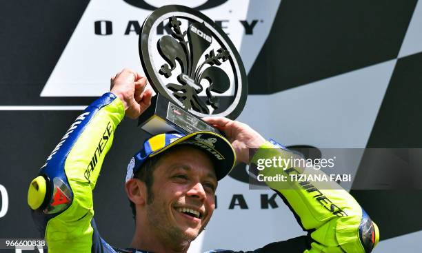 Movistar Yamaha's Italian rider Valentino Rossi celebrates on the podium after he placed third in the Moto GP Grand Prix at the Mugello race track on...