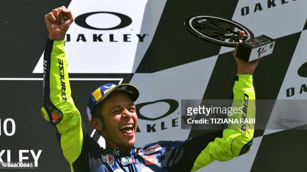 Movistar Yamaha's Italian rider Valentino Rossi celebrates on the podium after he placed third in the Moto GP Grand Prix at the Mugello race track on...