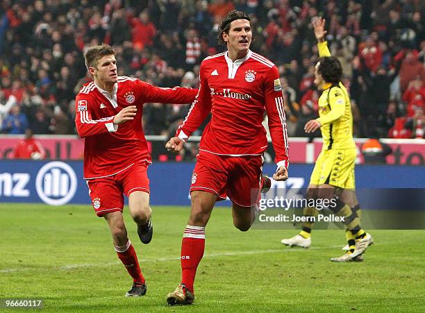 Mario Gomez of Bayern celebrates with his team mate Thomas Mueller after scoring his team's third goal during the Bundesliga match between FC Bayern...