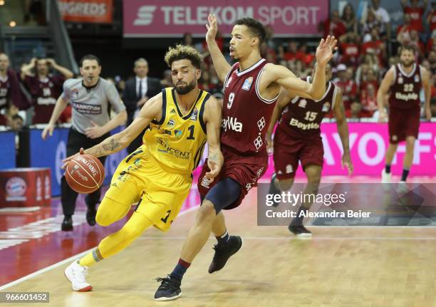 Jared Cunningham of FC Bayern Muenchen competes with Joshiko Saibou of ALBA Berlin during the first play-off game of the German Basketball Bundesliga...