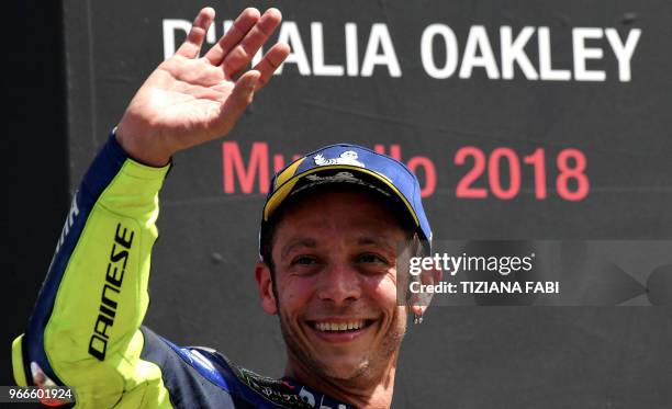 Movistar Yamaha's Italian rider Valentino Rossi celebrates on the podium after he placed third in the Moto GP Grand Prix at the Mugello race track on...