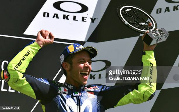 Movistar Yamaha's Italian rider Valentino Rossi celebrates on the podium after he placed third in the Moto GP Grand Prix at the Mugello race track on...