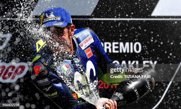 Movistar Yamaha's Italian rider Valentino Rossi celebrates on the podium after he placed third in the Moto GP Grand Prix at the Mugello race track on...