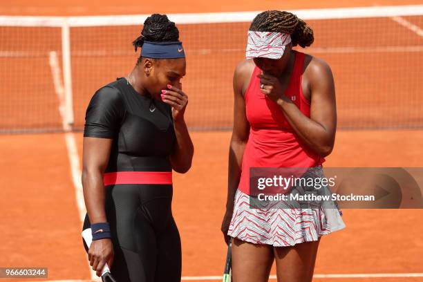 Venus Williams of The United States and partner Serena Williams in conversation during their ladies doubles fourth round match againstAndreja Klepac...