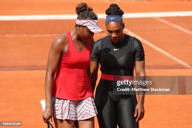 Venus Williams of The United States and partner Serena Williams in conversation during their ladies doubles fourth round match againstAndreja Klepac...