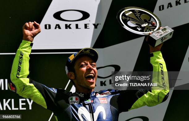 Movistar Yamaha's Italian rider Valentino Rossi celebrates on the podium after he placed third in the Moto GP Grand Prix at the Mugello race track on...