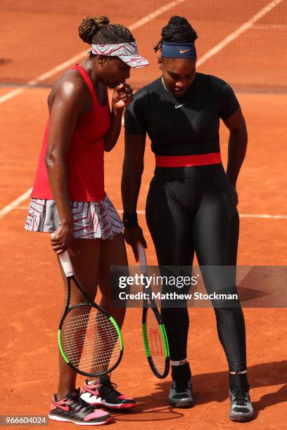 Venus Williams of The United States and partner Serena Williams in conversation during their ladies doubles fourth round match againstAndreja Klepac...