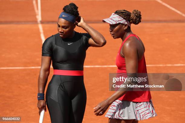 Venus Williams of The United States and partner Serena Williams in conversation during their ladies doubles fourth round match againstAndreja Klepac...