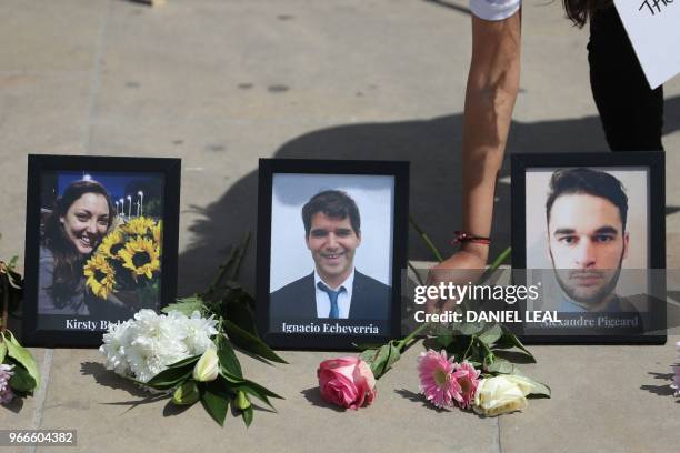 Flowers are placed alongside photographs of the people killed in the London Bridge terror attack, as members of various faiths gather on London...