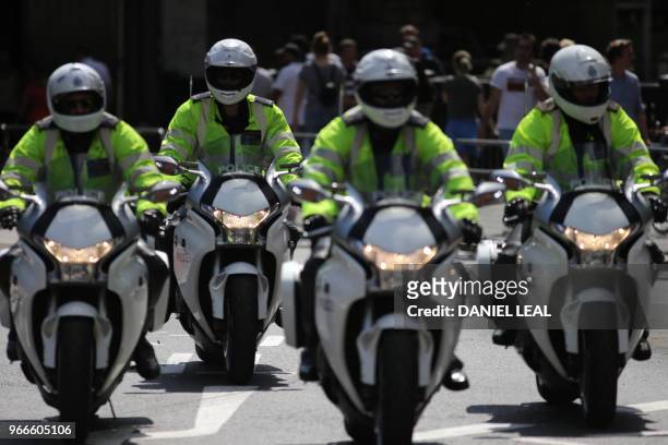 British police oficers travel on motor-bikes on London Bridge, London on June 3 prior to a commemoration service on the first anniversary of the...
