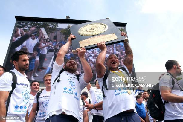 Castres' French prop Daniel Kotze and Castres' South African hooker Jody Jenneker raise the Bouclier de Brennus trophy as they celebrate with...