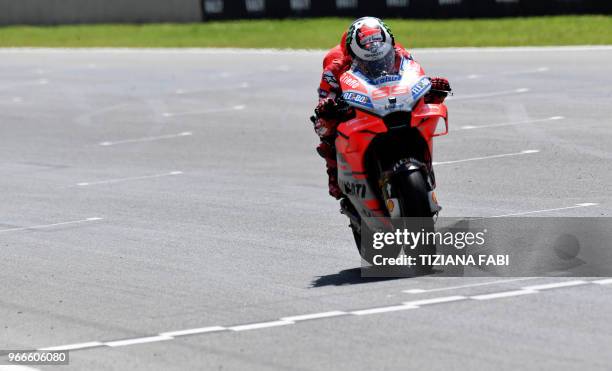 Ducati Team's Spanish rider Jorge Lorenzo crosses the finish line to win the Moto GP Grand Prix at the Mugello race track on June 3, 2018