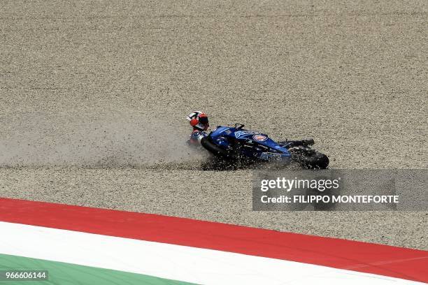 Italian rider Mattia Pasini of the Italtrans Racing Team crashes during the Moto2 race in the Moto GP Grand Prix at the Mugello race track on June 3,...