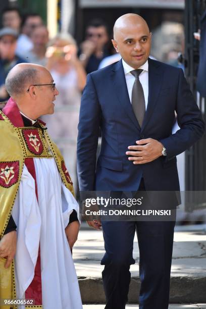 Britain's Home Secretary Sajid Javid is greeted by the Dean of Southwark, Andrew Nunn on her arrival for a Service of Commemoration on the first...