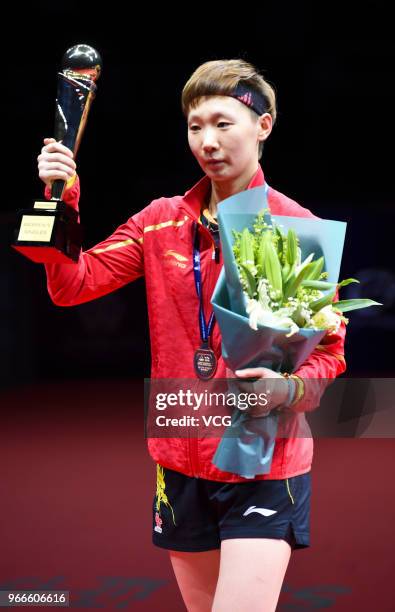 Wang Manyu of China celebrates with her trophy during awarding ceremony after winning women's singles final match against Ding Ning of China on day...