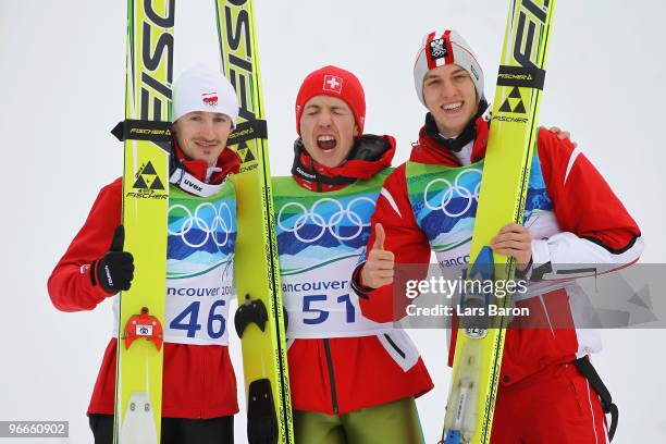 Adam Malysz of Poland wins the silver medal, Simon Ammann of Switzerland wins the gold medal and Gregor Schlierenzauer of Austria wins the bronze...