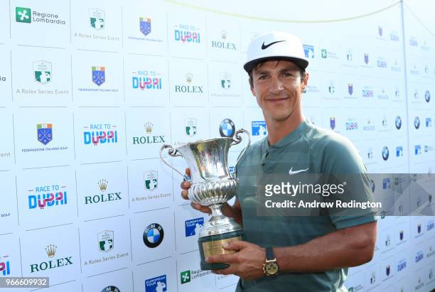 Thorbjorn Olesen of Denmark poses with the Italian Open trophy after victory in the competition during the final round of the Italian Open at...