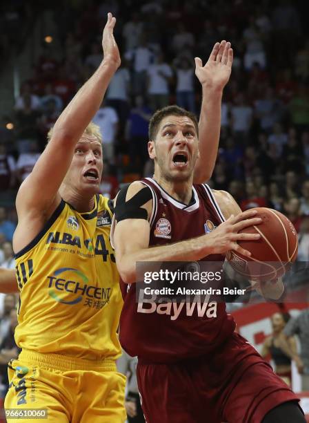 Stefan Jovic of FC Bayern Muenchen competes with Luke Sikma of ALBA Berlin during the first play-off game of the German Basketball Bundesliga finals...