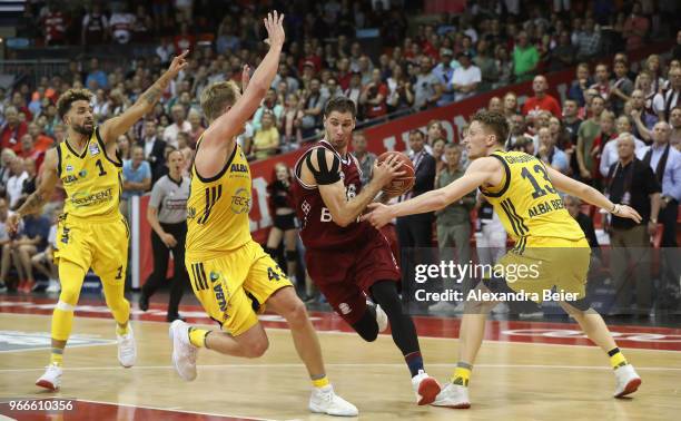 Stefan Jovic of FC Bayern Muenchen competes with Joshiko Saibou , Luke Sikma and Marius Grigonis of ALBA Berlin during the first play-off game of the...