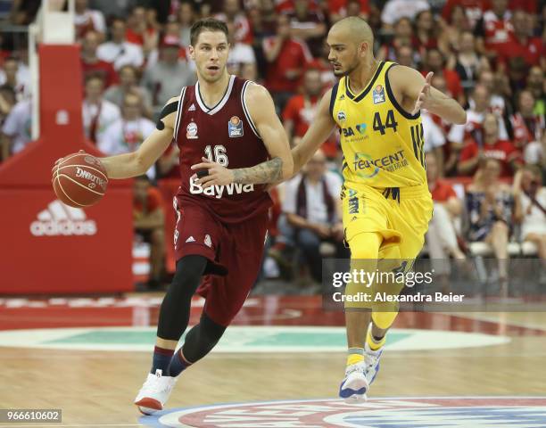 Stefan Jovic of FC Bayern Muenchen competes with Stefan Peno of ALBA Berlin during the first play-off game of the German Basketball Bundesliga finals...