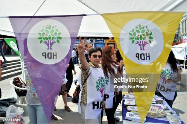 Supporter flashes a victory sign during the opening of a new election campaign booth of the pro-Kurdish Peoples' Democractic Party for the early...