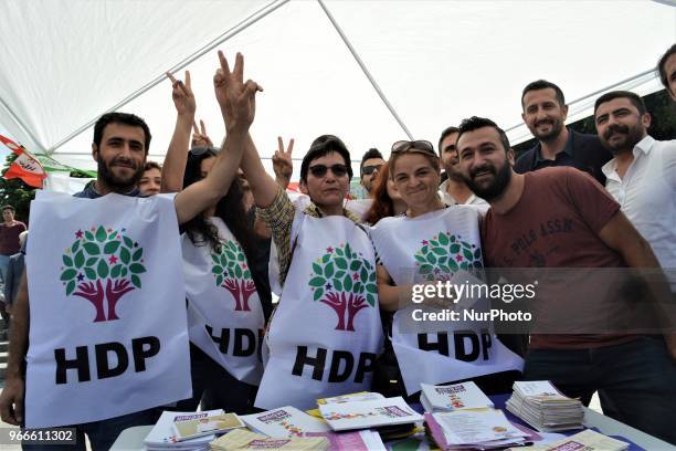 Supporters pose for a photo during the opening of a new election campaign booth of the pro-Kurdish Peoples' Democractic Party for the early...
