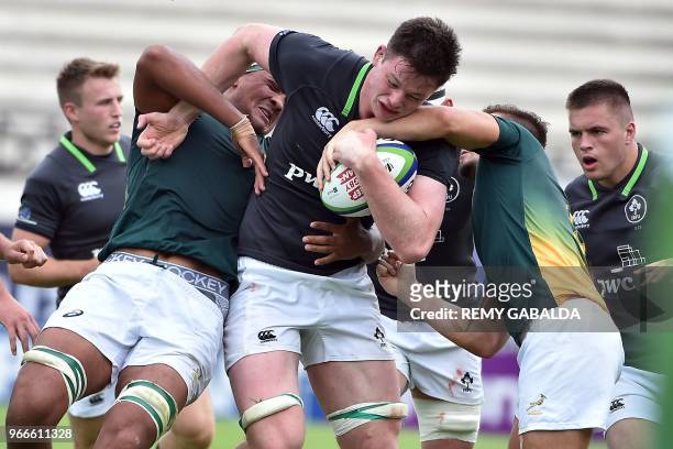 Ireland's lock Cormac Daly is tackled during the Rugby Union World Cup U20 championship match between South Africa and Ireland at the Parc des Dports...