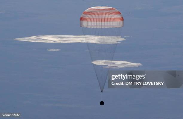 Russian Soyuz MS-07 space capsule lands about 150 km south-east of the Kazakh town of Dzhezkazgan, on June 3, 2018. A Soyuz space capsule with...