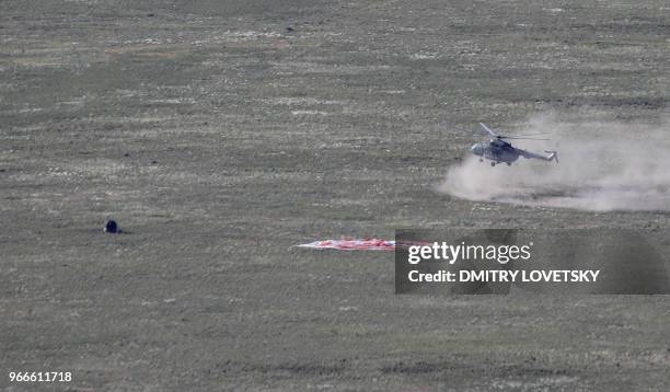 Russian Soyuz MS-07 space capsule lands about 150 km south-east of the Kazakh town of Dzhezkazgan, on June 3, 2018. - A Soyuz space capsule with...