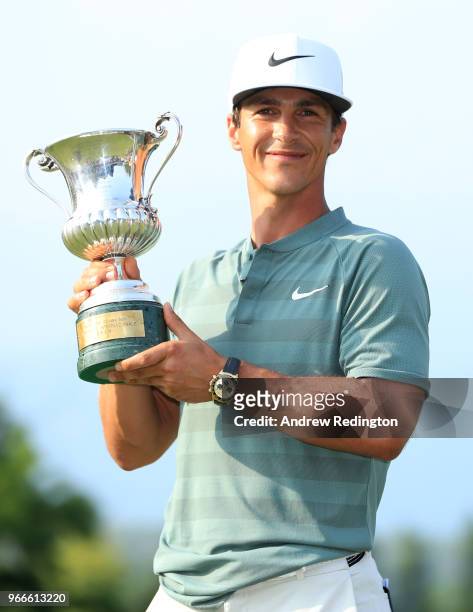 Thorbjorn Olesen of Denmark poses with the Italian Open trophy after victory in the competition during the final round of the Italian Open at...