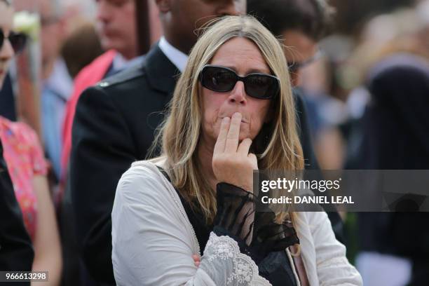 Members of the public react during a commemoration service on the first anniversary of the London Bridge terror attack, at Southwark Needle on London...