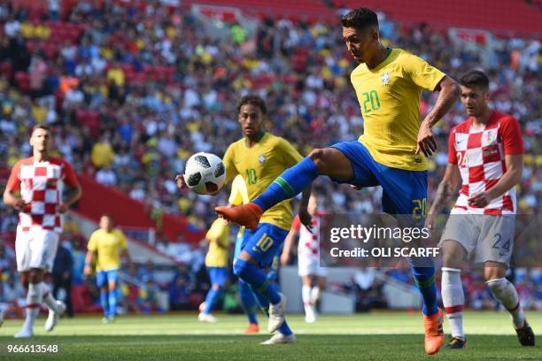 Brazil's striker Roberto Firmino shoots to score their second goal during the International friendly football match between Brazil and Croatia at...