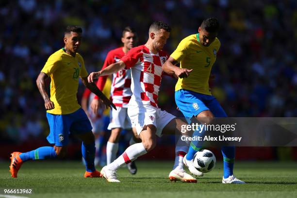 Casemiro of Brazil is challenged by Ivan Perisic of Croatia during the International Friendly match between Croatia and Brazil at Anfield on June 3,...