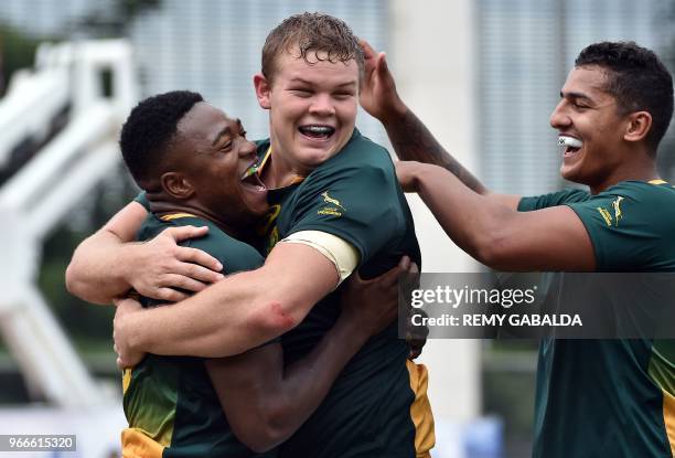 South Africa's center Wandisile Simelane celebrates with teammates after scoring a try during the World Rugby U20 Championship match South Africa vs...