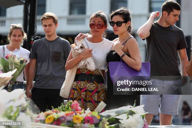 Members of the public react during a commemoration service on the first anniversary of the London Bridge terror attack, at Southwark Needle on London...