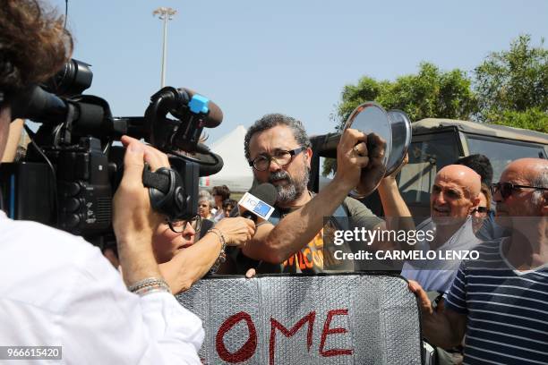 People protest against the visit of Italy's new hardline interior minister in Pozzallo, sicily, on June 3,2018. - The head of the far-right League is...