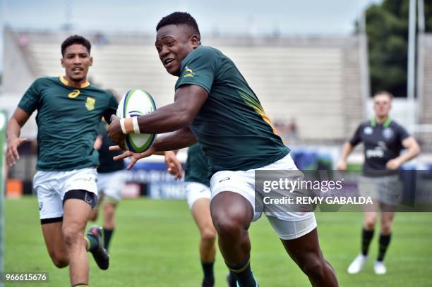 South Africa's center Wandisile Simelane runs to score a try during the World Rugby U20 Championship match South Africa vs Ireland at the Parc des...