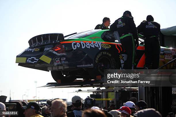 Crew members for Danica Patrick, driver of the GoDaddy.com Chevrolet, load the car in to the hauler after being involved in a crash during the NASCAR...