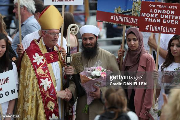 Bishop of Southwark Christopher Chessun meets members of the public during a commemoration service on the first anniversary of the London Bridge...