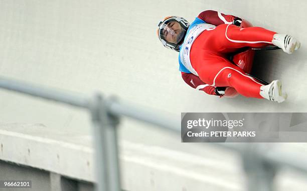 Macadonia's Bogdan Macovei steers his luge through a high speed corner called Goldrush Trail during the men's singles luge practise at the Whistler...